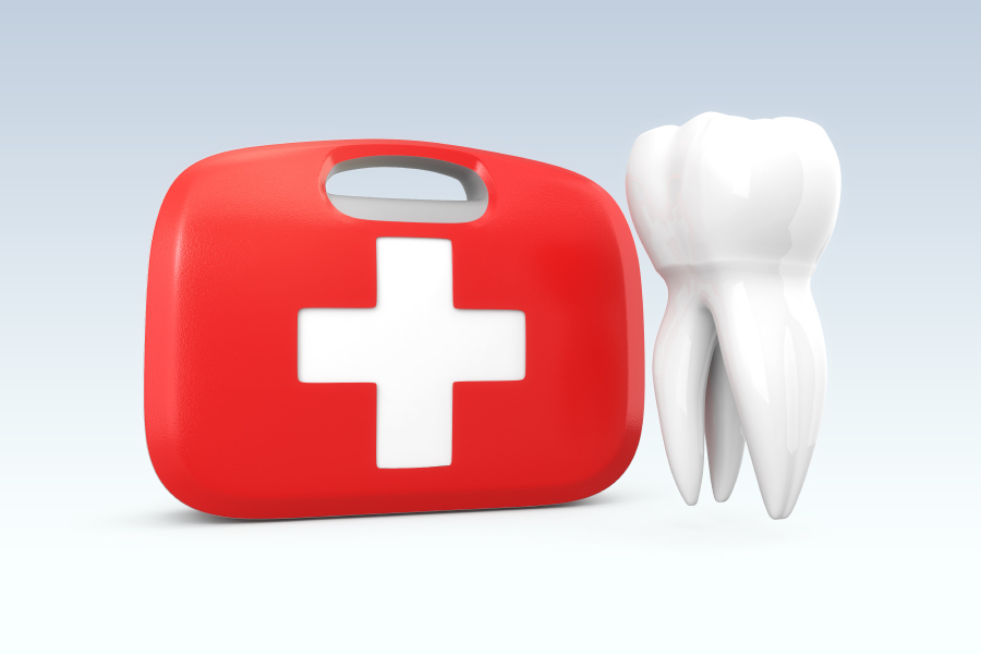 Red first aid kit next to a white tooth