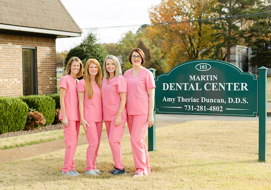 Staff women smiling outside Martin Dental Center